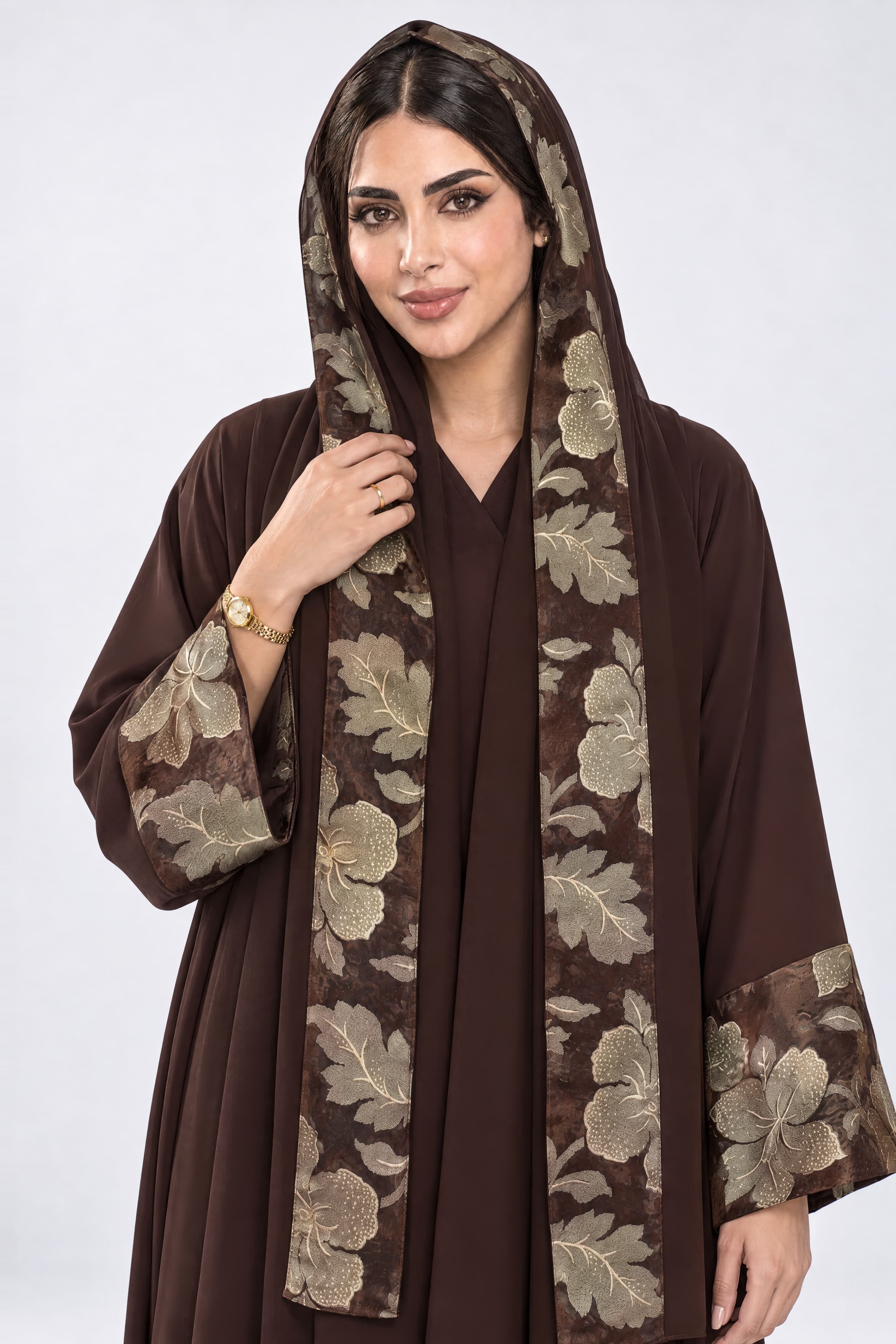 Brown crepe abaya with details at the sleeves and scarf.