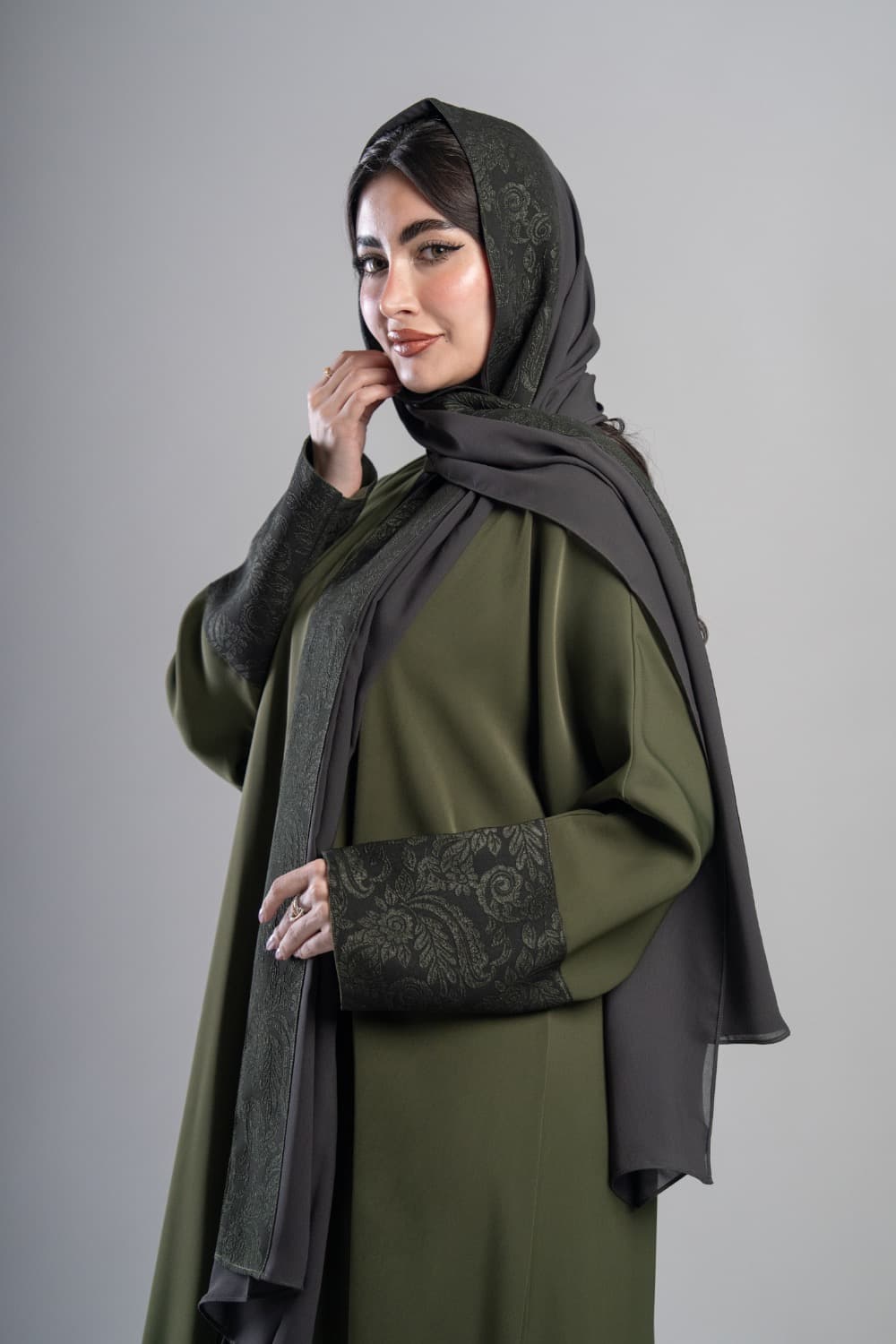 تألقي بعباية كريب أخضر زيتي
 عباية كريب أخضر زيتي بتركيبة من قماش أخضر داكن بنقشة زهرية على الأكمام، التدرج بين اللونين يعطي العباية طابعاً مميزاً وأنيقاً
 تركيبة قماش منقوش على الأكمام
 تتميز هذه العباية بتركيبة من القماش الأخضر الداكن المنقوش بنقشة زهرية على الأكمام، التفصيل يضيف عمقاً للتصميم ويجعله متكاملاً
 الطرحه المتناسقة لإكمال إطلالتك
 تأتي العباية مع طرحة تحمل نفس تركيبة القماش المنقوش لتكمل الإطلالة بتناسق كامل، ارتديها بثقة في أي مناسبة